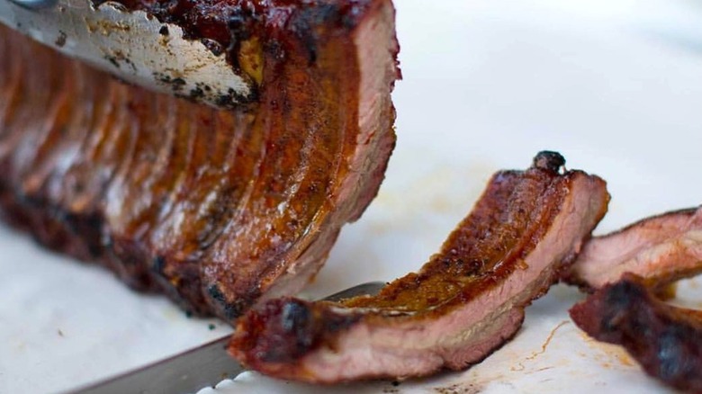 Ribs are sliced from the rack at Black Market StP