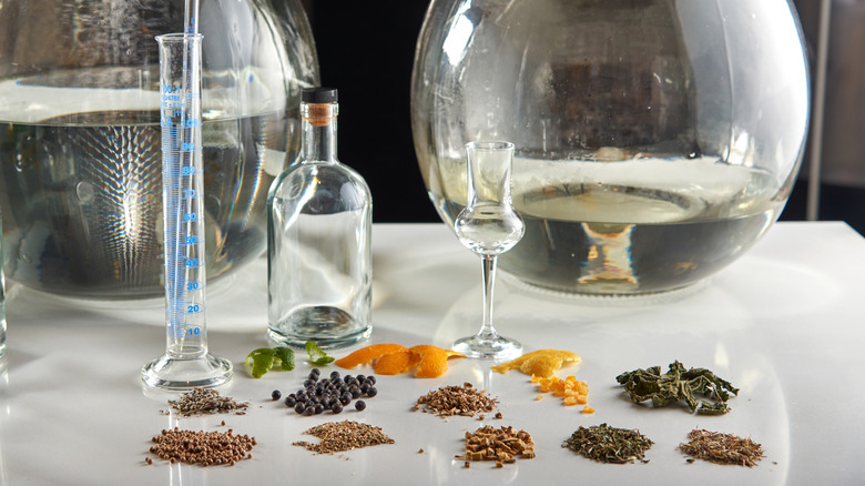 The botanical ingredients used to make gin set on a table in a distillery