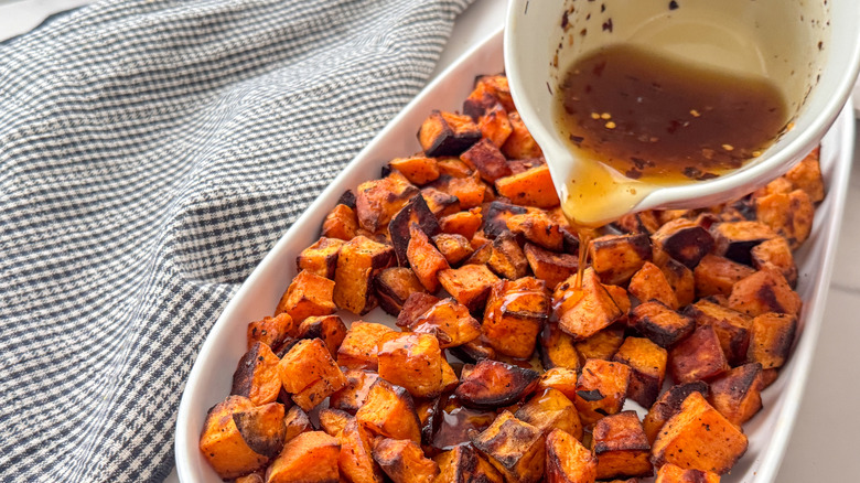 pouring hot honey over potatoes