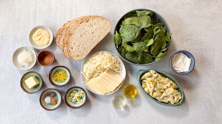 Ultimate spinach artichoke grilled cheese ingredients on countertop