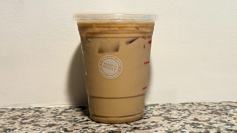 Small Dunkin' Nutty Pumpkin Iced Coffee on a granite counter top