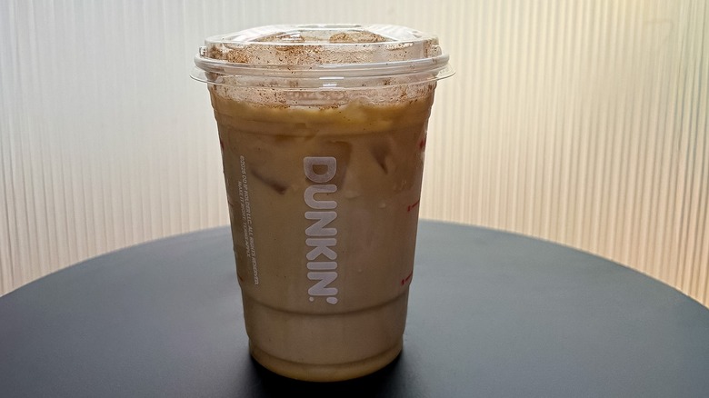 Small Dunkin' Pumpkin Cloud Dunkalatte on a black table