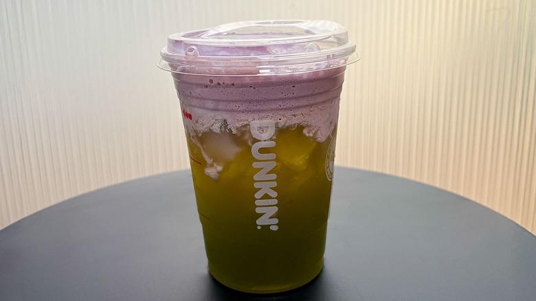 Small Dunkin' Sour Apple Energy on a black table